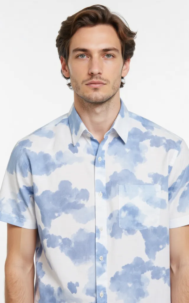 A French model wearing a Cloud pattern   printed shirt, against a white background, in a front   facing bust portrait